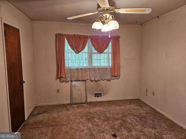 empty room featuring ceiling fan, crown molding, and carpet flooring