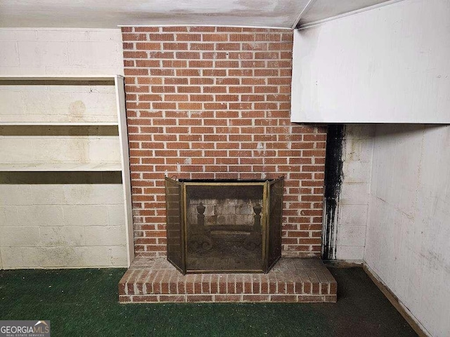 interior details featuring carpet floors and a brick fireplace