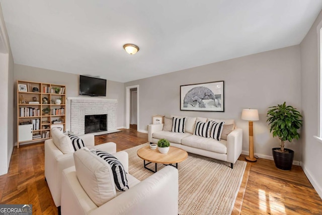 living room with hardwood / wood-style floors and a fireplace