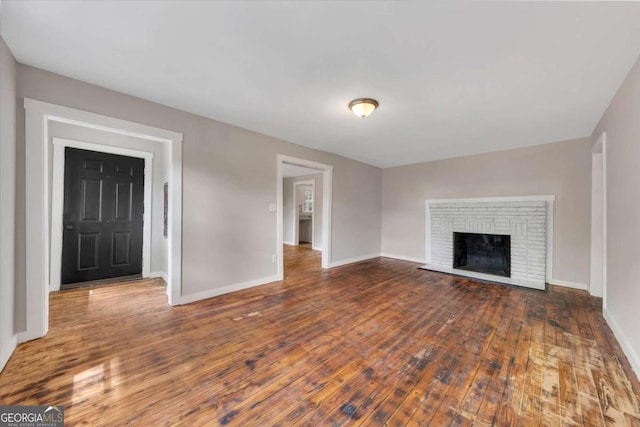 unfurnished living room featuring dark hardwood / wood-style floors and a fireplace