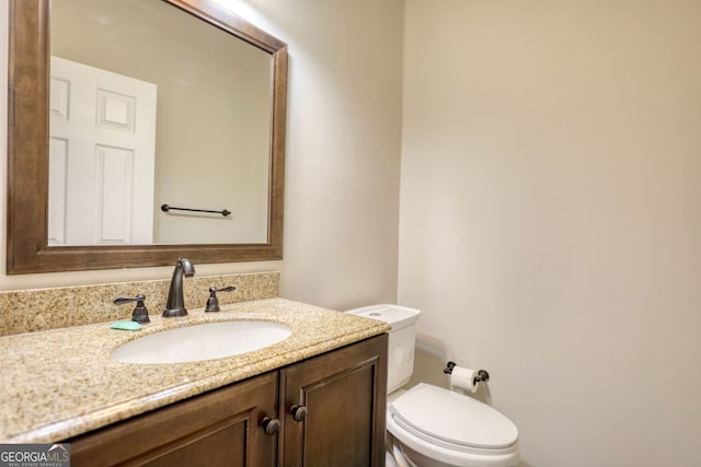 bathroom with toilet and vanity