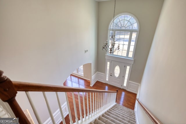 entryway with wood-type flooring and a notable chandelier