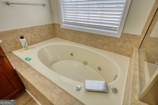 bathroom featuring tiled tub