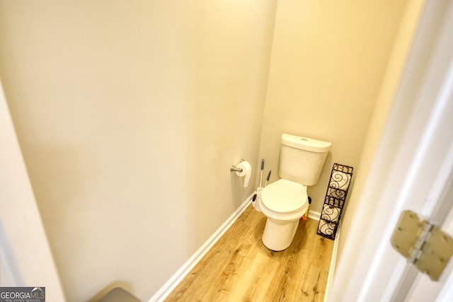 bathroom featuring hardwood / wood-style floors and toilet