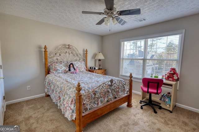 bedroom with ceiling fan, a textured ceiling, and carpet flooring