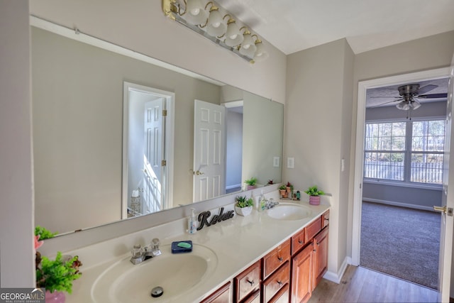 bathroom with ceiling fan, hardwood / wood-style floors, and vanity