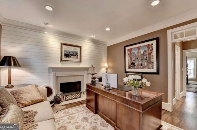 home office featuring ornamental molding and light hardwood / wood-style floors