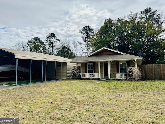 view of front of property featuring a front yard, a porch, and a carport