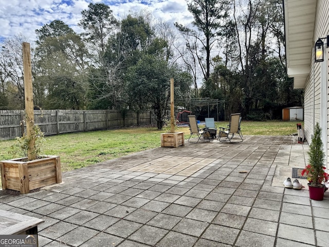 view of patio featuring a storage shed