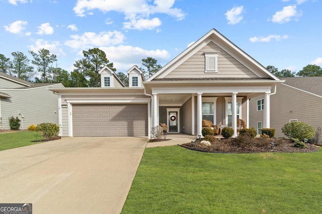 view of front of house with a front lawn, covered porch, and a garage