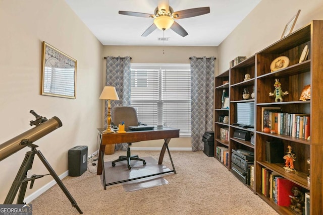 carpeted home office with ceiling fan