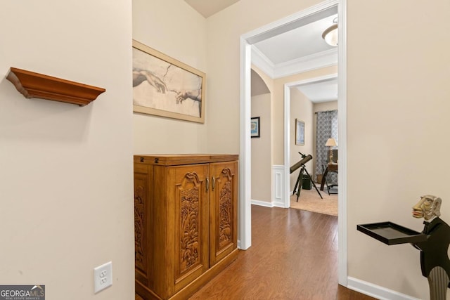 corridor with crown molding and hardwood / wood-style floors