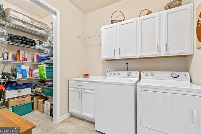 laundry area featuring washer and dryer and cabinets