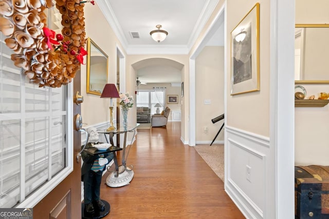 interior space with ornamental molding and hardwood / wood-style flooring