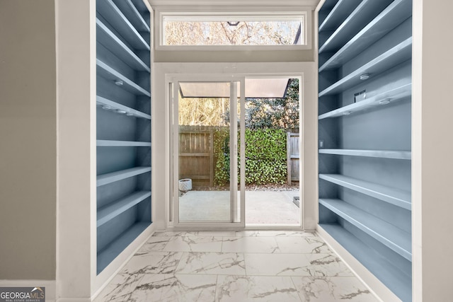 spacious closet featuring marble finish floor