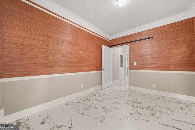 unfurnished room featuring marble finish floor, baseboards, and ornamental molding