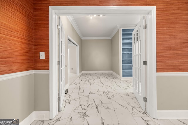 hallway featuring marble finish floor, wooden walls, ornamental molding, french doors, and baseboards