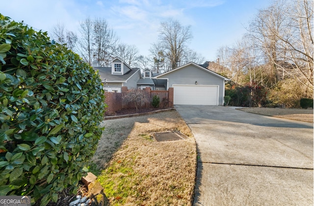 exterior space with a garage and concrete driveway