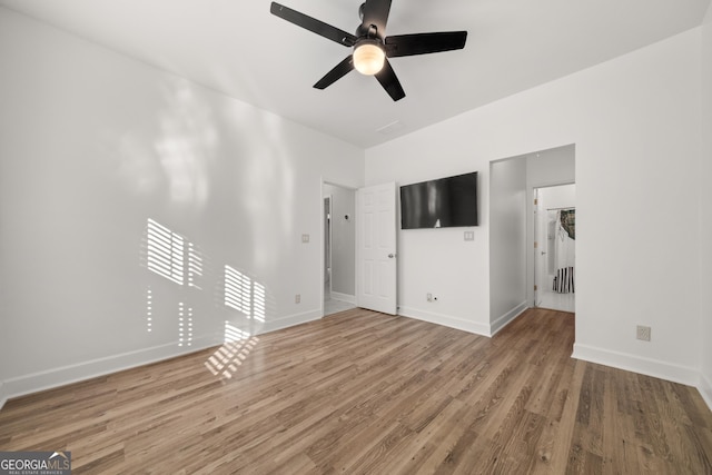 unfurnished living room with hardwood / wood-style flooring and ceiling fan