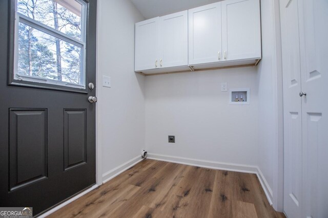 laundry area featuring cabinets, dark hardwood / wood-style flooring, hookup for a washing machine, and electric dryer hookup