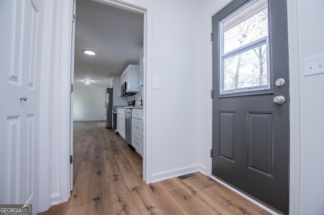 foyer entrance featuring light hardwood / wood-style flooring