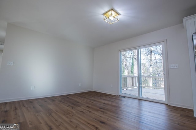 spare room with dark hardwood / wood-style flooring