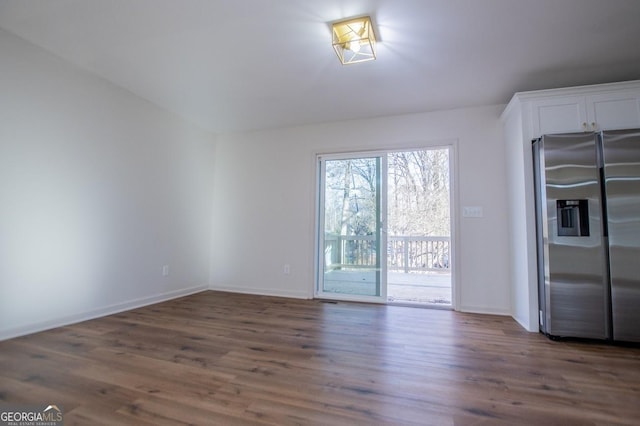 empty room featuring dark hardwood / wood-style flooring