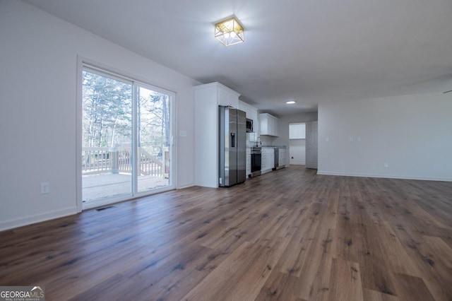 unfurnished living room featuring dark wood-type flooring