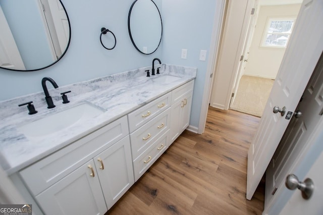 bathroom with hardwood / wood-style floors and vanity