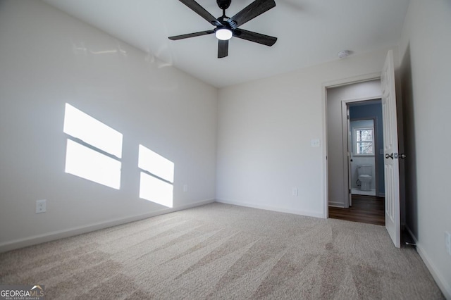 carpeted spare room featuring ceiling fan