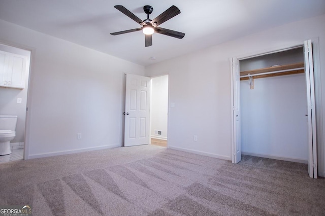 unfurnished bedroom featuring ceiling fan, connected bathroom, a closet, and carpet floors