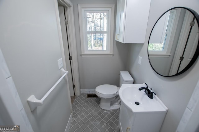 bathroom with toilet and tile patterned flooring