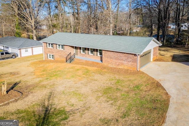 ranch-style home featuring a garage and a front lawn