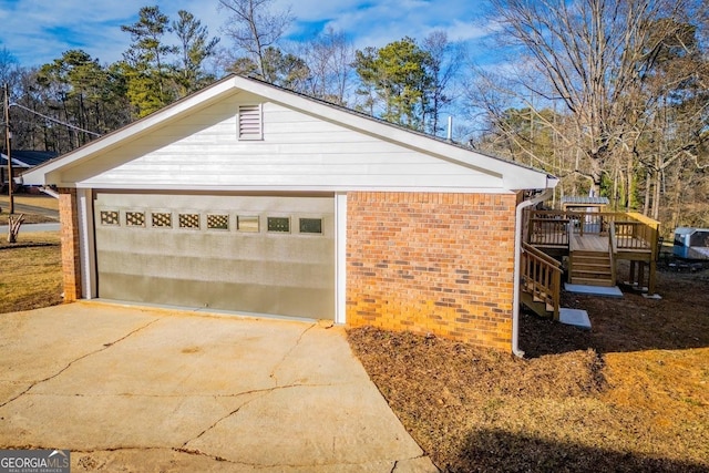 view of side of property with a garage, a wooden deck, and an outdoor structure