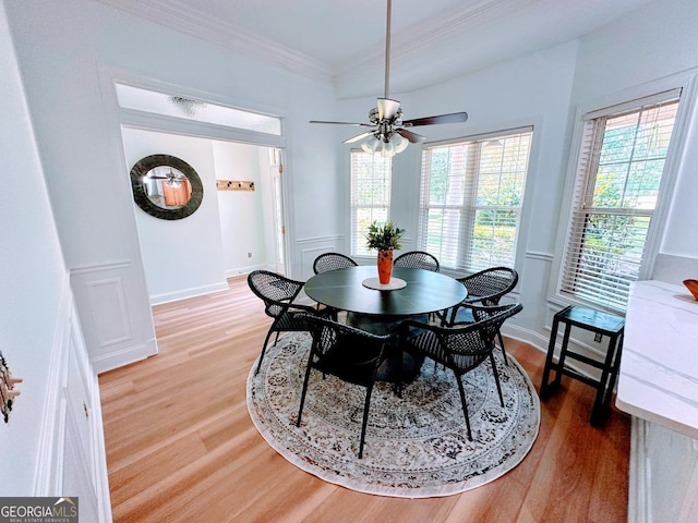 dining space featuring crown molding, hardwood / wood-style floors, and ceiling fan