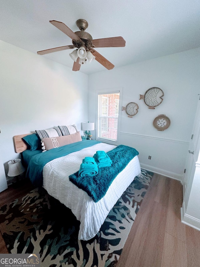 bedroom featuring hardwood / wood-style floors and ceiling fan