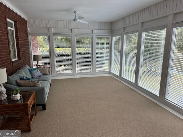 sunroom / solarium featuring ceiling fan