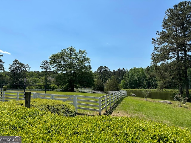 view of yard featuring a water view and a rural view