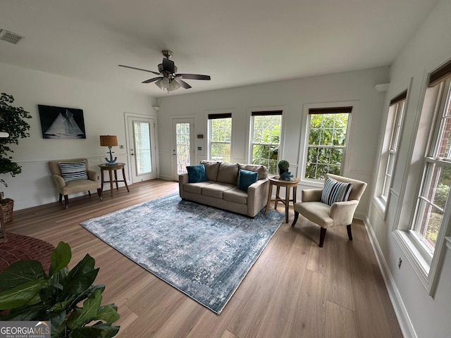 living room featuring ceiling fan and light hardwood / wood-style floors