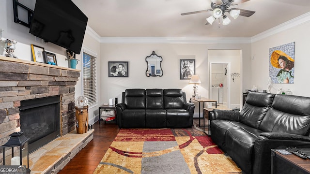 living room featuring a fireplace, a ceiling fan, baseboards, ornamental molding, and dark wood-style floors