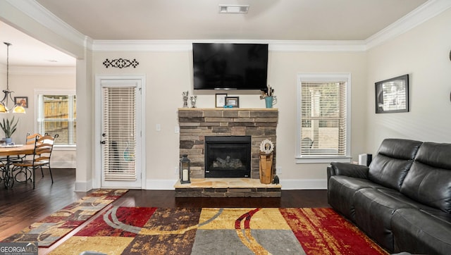 living room featuring dark wood finished floors, visible vents, and crown molding