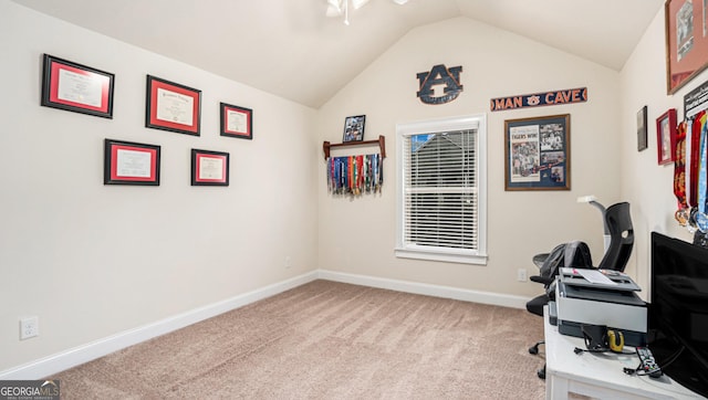 office area featuring light carpet, vaulted ceiling, and baseboards