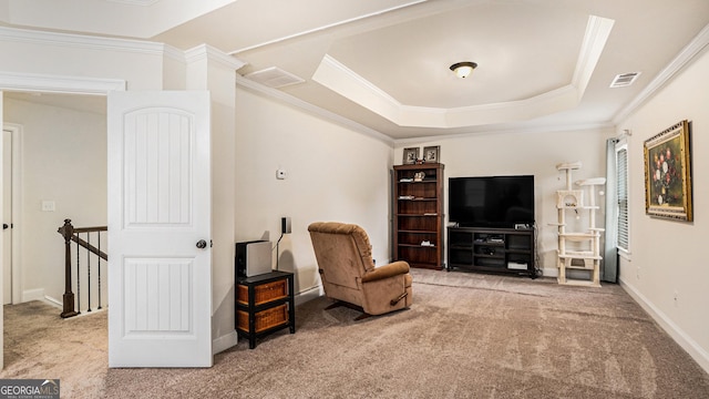 living area with ornamental molding, carpet, a raised ceiling, and visible vents