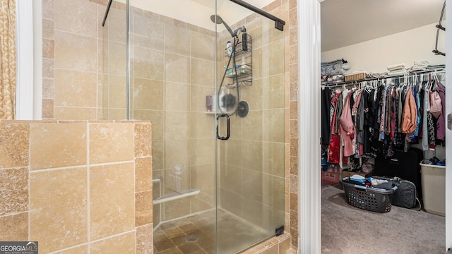 full bath featuring a spacious closet and a shower stall