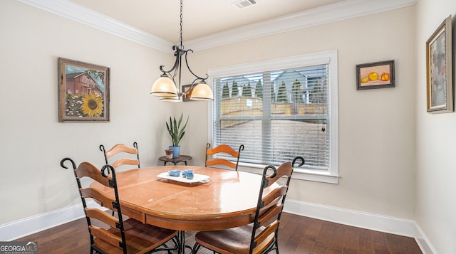 dining space featuring dark wood-style floors, visible vents, crown molding, and baseboards