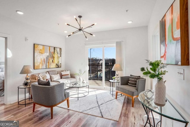 living area featuring a chandelier, recessed lighting, and wood finished floors