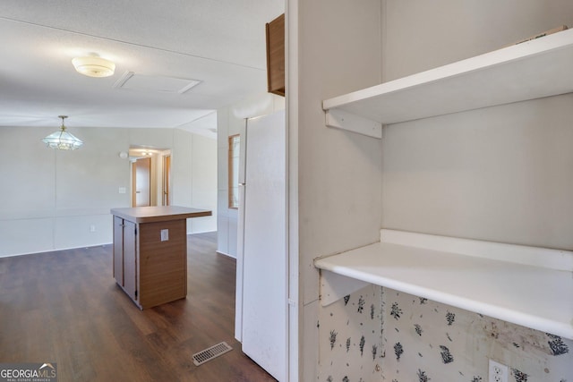 interior space with vaulted ceiling and dark hardwood / wood-style flooring