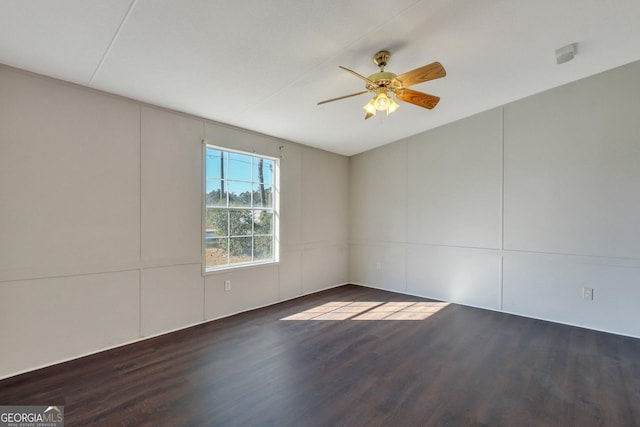 spare room featuring ceiling fan and dark hardwood / wood-style flooring