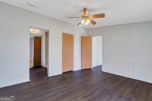 unfurnished room with ceiling fan and dark wood-type flooring