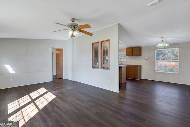 unfurnished living room featuring ceiling fan and dark hardwood / wood-style floors